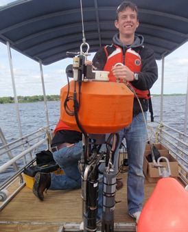 Anthony Weinke holds subsurface buoy sensors in Muskegon Lake